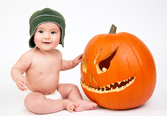 Image showing Happy Six Month Old Boy Sitting in Diaper With Carved Halloween 