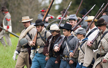 Image showing Civil War Re-enactment Union Soldiers March Holding Muskets Duri