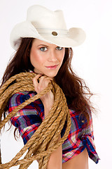 Image showing Beautiful Cowgirl Smiles in White Cowboy Hat Holding Rope