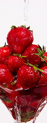 Image showing Water Flowing Through Fresh Strawberries in Parfait Glass