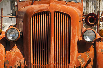 Image showing Old Orange Vinatge Fire Truck Sits Rusting in Desert Country