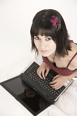 Image showing Woman Works on Laptop Computer Sitting on Floor
