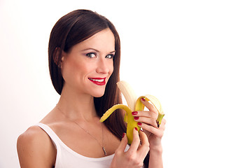 Image showing Attractive Woman eats RAW food fruit banana white background