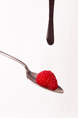 Image showing Chocolate Sauce Falling Berries Rasberries on Silver Spoon