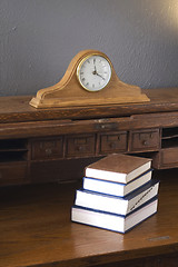 Image showing Books on the Antique Rolltop Desk with Mantle Clock