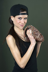 Image showing Skinny Female Baseball Player Holds Ball in Glove