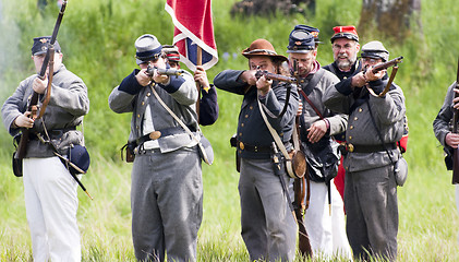 Image showing Civil War Re-enactment Confederate Soldiers Fire Rifles During B