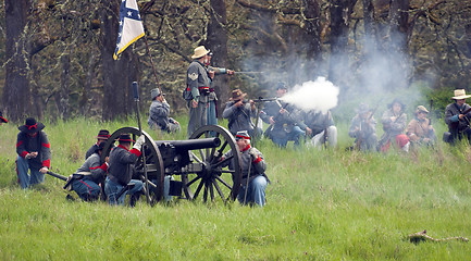 Image showing Civil War Re-enactment Confederate Soldiers Fire Rifles During B