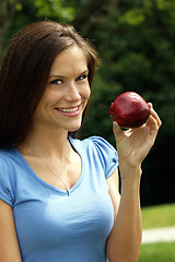 Image showing Attractive Woman Smiling in Park with Red Delicious Apple 