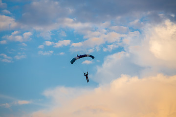 Image showing unidentified skydiver, parachutist on blue sky