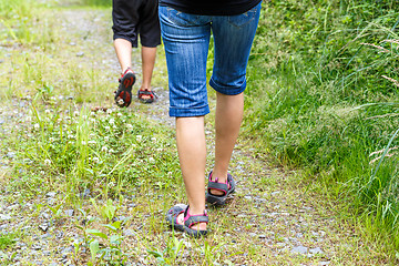 Image showing Woman walking with son cross country