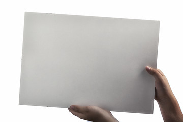 Image showing White Plastic laminate sign held up by hands
