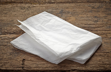 Image showing white wrapping paper on wooden table