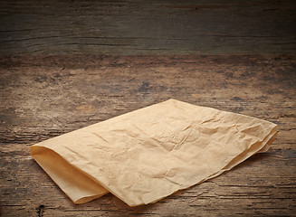 Image showing brown wrapping paper on wooden table