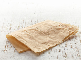 Image showing brown wrapping paper on wooden table