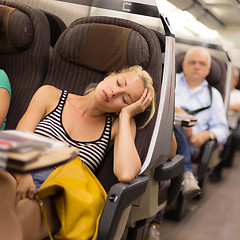 Image showing Lady traveling napping on a train.
