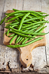 Image showing green string beans on wooden board