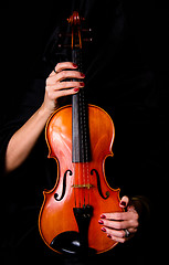 Image showing Female Violinist Holds Bow Across Saturated Musical Violin Acous