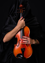 Image showing Female Violinist Holds Bow Across Saturated Musical Violin Acous