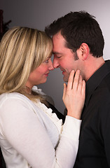 Image showing Young Couple Man Woman Engaged Standing Hugging Kissing Embracin