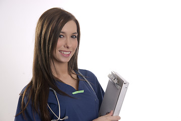 Image showing Beautiful Brunette Nurse Holds Patient Medical Chart Data in Cli