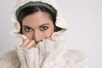 Image showing Attractive Woman Covering Half Her Face with Sweater