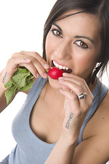 Image showing Beautiful Brunette American Woman Enjoys the Taste of Radish