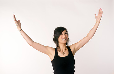 Image showing Pretty Brunette Woman Holds Arms Outstretched Jubilant Looking U