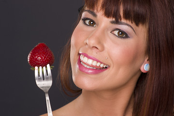 Image showing Attractive Woman Holding a Strawberry