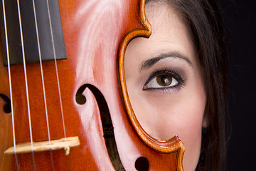 Image showing Beautiful Female Face Behind Colorful Musical Violin