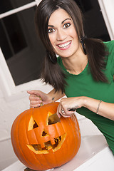 Image showing Excited Happy Woman Cutting Carving Halloween Pumpkin Jack-O-Lan