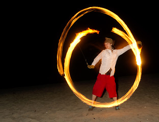 Image showing Man on Beach Spins Burning Chains Playing with Fire