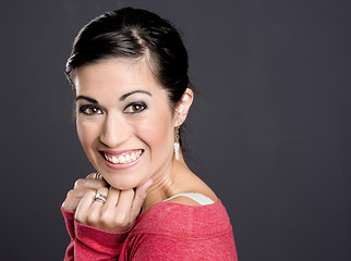 Image showing Pretty Woman in a red sweater looking at the camera