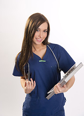 Image showing Beautiful Brunette Nurse Holds Patient Medical Chart Data in Cli