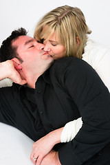 Image showing Young Couple Man Woman Engaged Laying Down Kissing Embracing