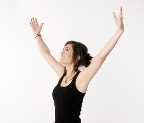 Image showing Pretty Brunette Woman Holds Arms Outstretched Jubilant Looking U