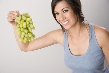 Image showing Wholesome Woman Holds Cluster of Beautiful Fruit Food Grapes