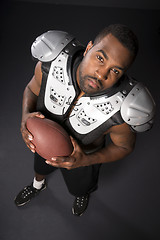 Image showing African American Man Football Player Shoulder Pads Looking at Ca