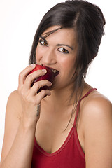 Image showing An Apple a Day Woman Bites into Red Delicious Apple