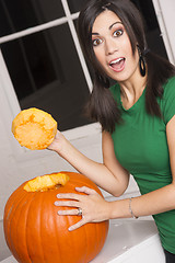 Image showing Excited Happy Woman Cutting Carving Halloween Pumpkin Jack-O-Lan