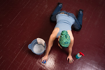 Image showing Adorable Housewife Maid Doing Cleaning Chores Scrubbing Floor Ha