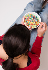 Image showing Happy Attractive Woman Eats Bowl Colorful Breakfast Cereal