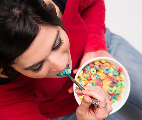 Image showing Happy Attractive Woman Eats Bowl Colorful Breakfast Cereal