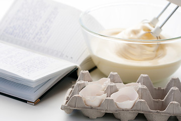 Image showing Whisk with eggs in a bowl