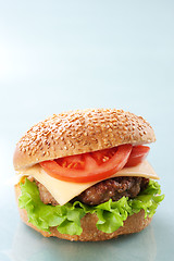 Image showing Cheeseburger with tomatoes and lettuce