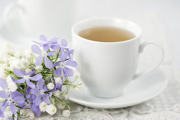 Image showing Cup of tea and flowers 