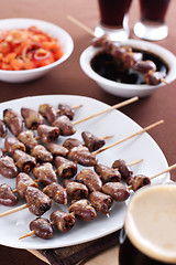 Image showing Grilled chicken hearts on skewers