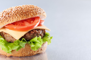 Image showing Cheeseburger with tomatoes and lettuce