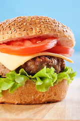 Image showing Cheeseburger with tomatoes and lettuce