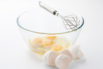 Image showing Whisk with eggs in a bowl